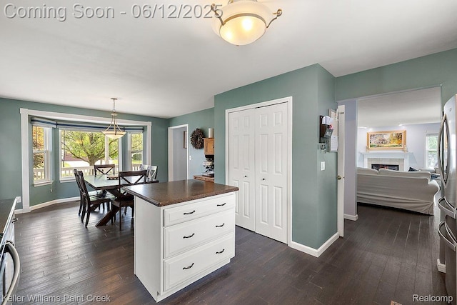 46341 Jasmine Ct, Chesterfield, MI 48047 - kitchen with dark countertops, plenty of natural light, dark wood-type flooring, and white cabinetry