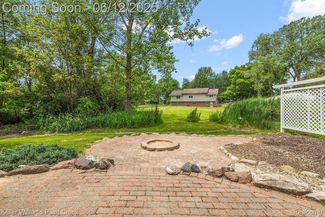 46341 Jasmine Ct, Chesterfield, MI 48047 - view of grassy yard with a fire pit and a patio area