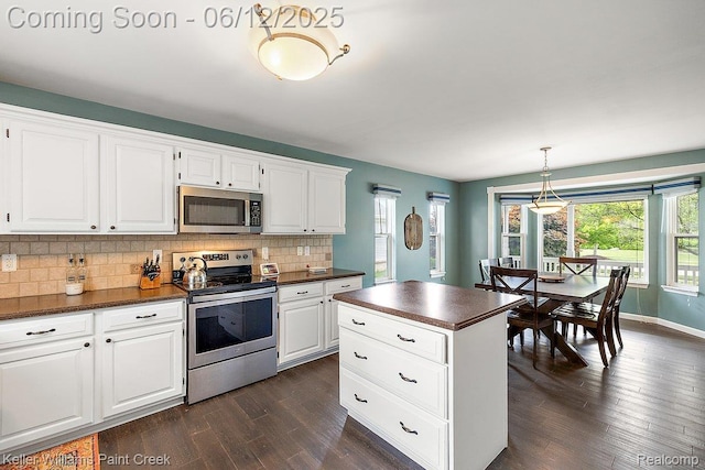 46341 Jasmine Ct, Chesterfield, MI 48047 - kitchen with appliances with stainless steel finishes, dark countertops, dark wood-style floors, decorative backsplash, and white cabinets