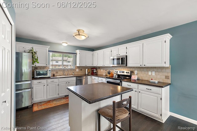 46341 Jasmine Ct, Chesterfield, MI 48047 - kitchen featuring stainless steel appliances, dark countertops, dark wood-style flooring, and tasteful backsplash