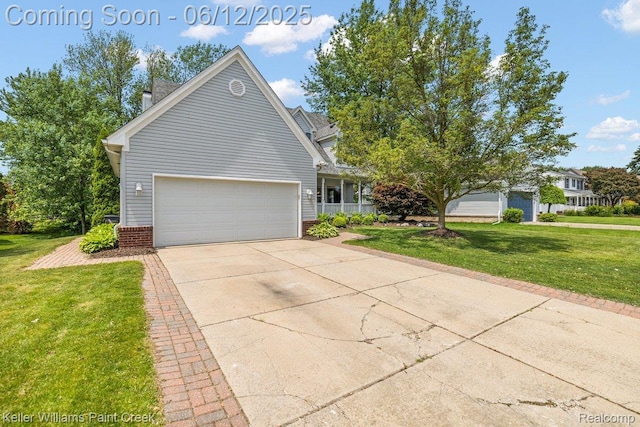 46341 Jasmine Ct, Chesterfield, MI 48047 - view of front of home featuring a front lawn, brick siding, driveway, and a garage