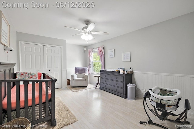 46341 Jasmine Ct, Chesterfield, MI 48047 - bedroom featuring wood finished floors, a closet, wainscoting, and ceiling fan