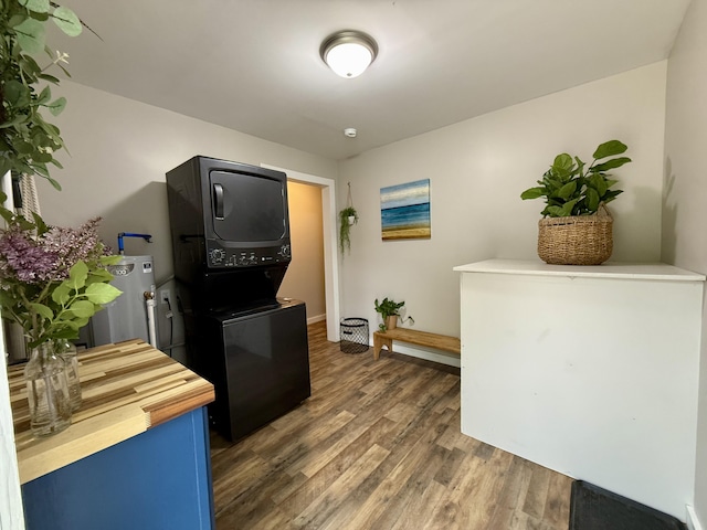 4223 S Harvard Ave, Baldwin, MI 49304 - kitchen with stacked washer / dryer, wood finished floors, water heater, and butcher block counters