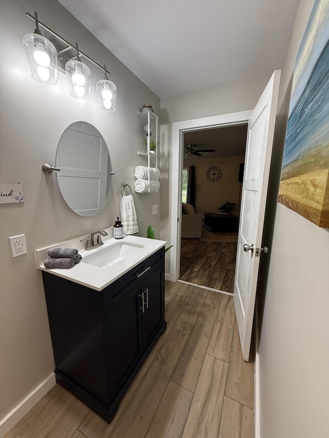 4223 S Harvard Ave, Baldwin, MI 49304 - bathroom with wood finished floors, vanity, baseboards, and a ceiling fan