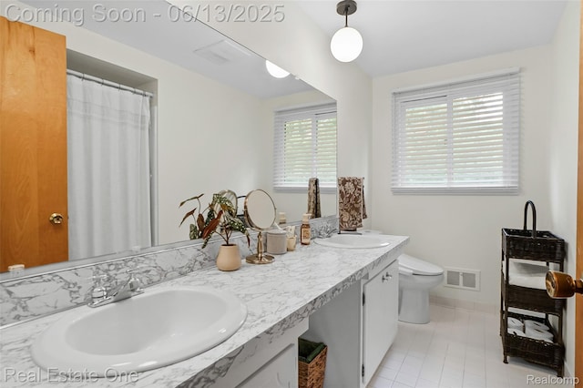 23229 Gilbar St, Novi, MI 48375 - bathroom featuring double vanity and tile patterned flooring