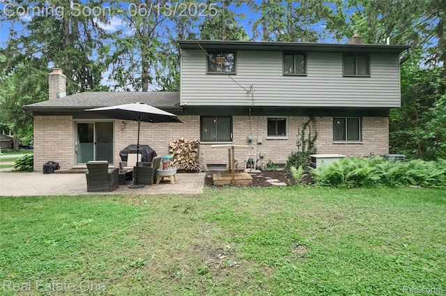 23229 Gilbar St, Novi, MI 48375 - back of property with a chimney, a lawn, a patio area, and brick siding