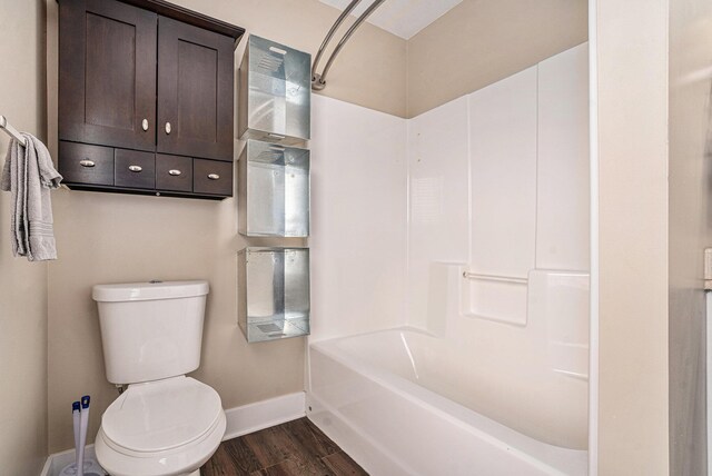 119 E Eliza St, Schoolcraft, MI 49087 - bathroom featuring baseboards, toilet, wood finished floors, and  shower combination