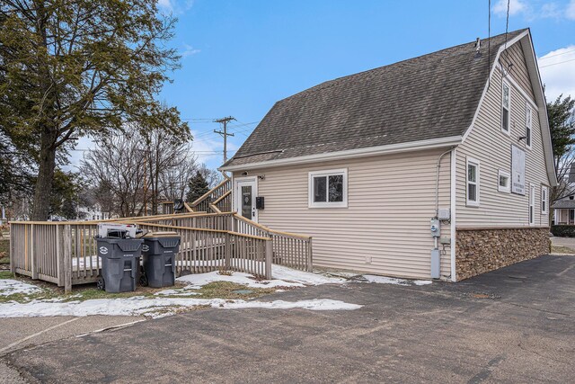 119 E Eliza St, Schoolcraft, MI 49087 - view of home's exterior with a shingled roof and a wooden deck