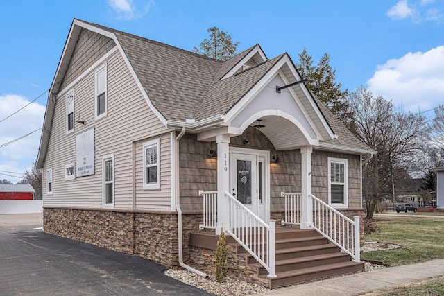 119 E Eliza St, Schoolcraft, MI 49087 - view of front of house featuring roof with shingles and stone siding