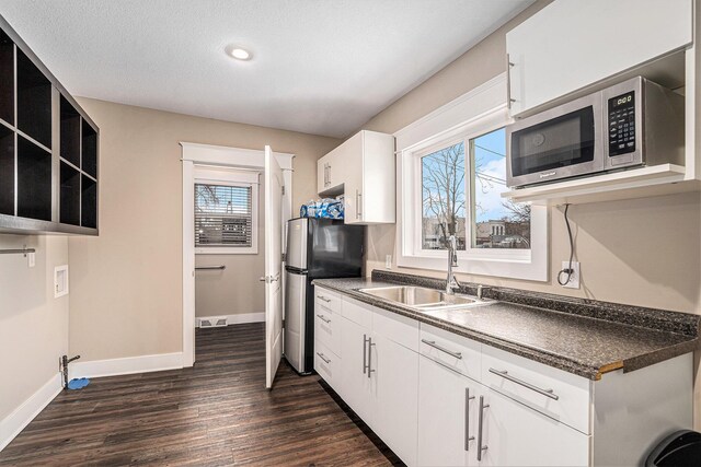 119 E Eliza St, Schoolcraft, MI 49087 - kitchen with a sink, appliances with stainless steel finishes, dark wood-type flooring, baseboards, and dark countertops