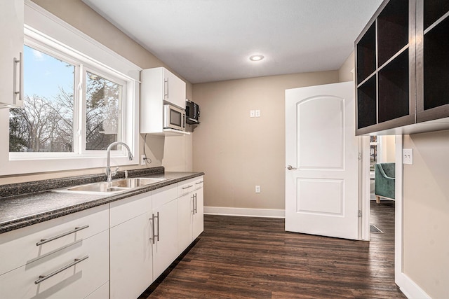 119 E Eliza St, Schoolcraft, MI 49087 - kitchen featuring a sink, dark countertops, baseboards, dark wood-type flooring, and recessed lighting