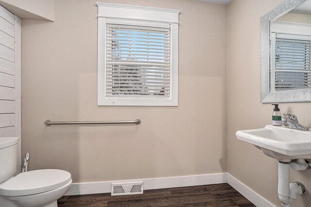 119 E Eliza St, Schoolcraft, MI 49087 - bathroom featuring toilet, baseboards, and wood finished floors