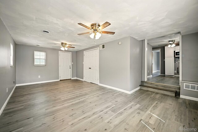 2070 Harwine St, Flint, MI 48532 - empty room featuring ceiling fan and wood finished floors