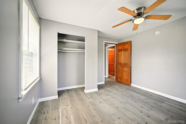 2070 Harwine St, Flint, MI 48532 - unfurnished bedroom featuring light wood-style floors, a closet, and ceiling fan