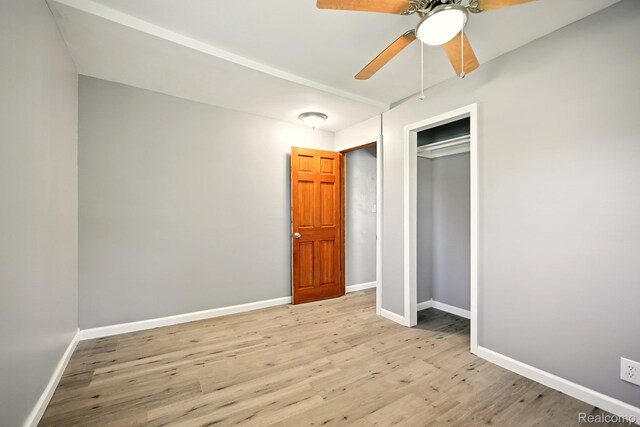 2070 Harwine St, Flint, MI 48532 - unfurnished bedroom featuring wood finished floors, a closet, and ceiling fan