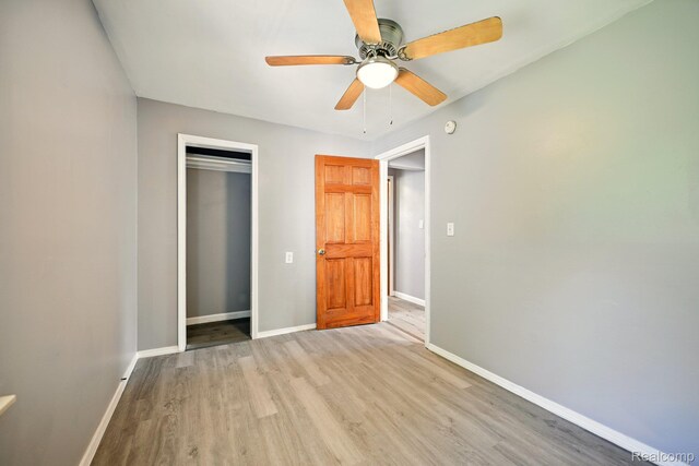 2070 Harwine St, Flint, MI 48532 - unfurnished bedroom with light wood-style floors, a closet, and ceiling fan