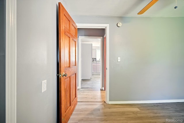 2070 Harwine St, Flint, MI 48532 - hallway with baseboards and light wood-style flooring
