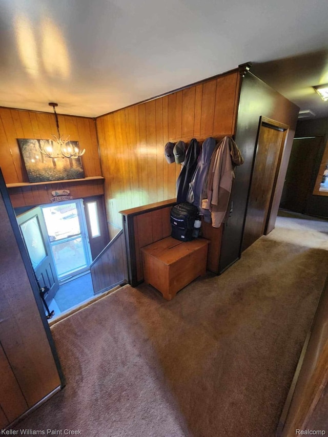 370 Wales Ridge Rd, Wales, MI 48027 - foyer featuring carpet floors, wooden walls, and a chandelier