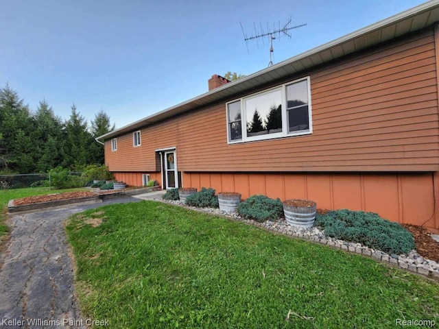 370 Wales Ridge Rd, Wales, MI 48027 - view of side of property featuring a lawn and a chimney