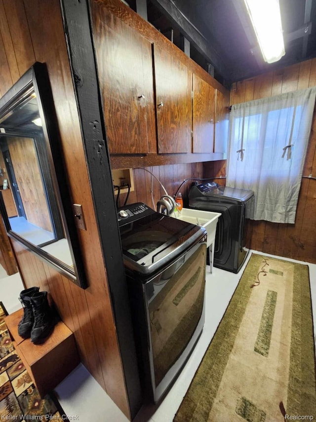 370 Wales Ridge Rd, Wales, MI 48027 - kitchen featuring washer and dryer and wood walls