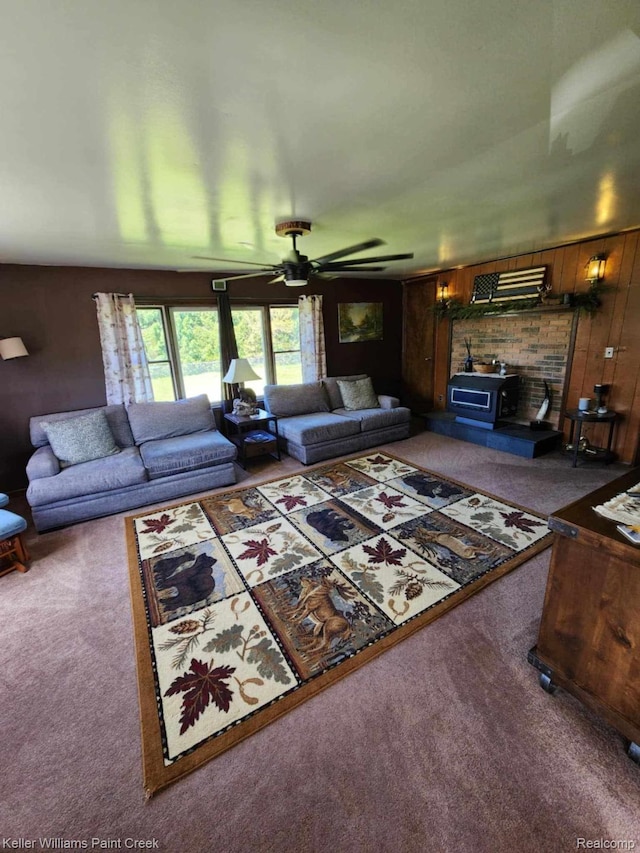 370 Wales Ridge Rd, Wales, MI 48027 - living area featuring carpet floors, a wood stove, ceiling fan, and wood walls