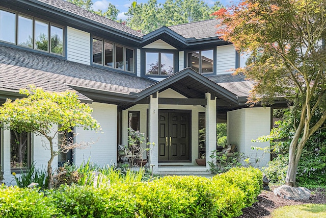 2002 Valleyview Dr, Ann Arbor, MI 48105 - entrance to property featuring a shingled roof, brick siding, and covered porch