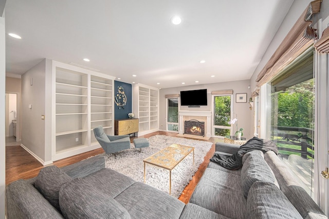 2002 Valleyview Dr, Ann Arbor, MI 48105 - living area with wood finished floors, baseboards, recessed lighting, built in features, and a fireplace with flush hearth