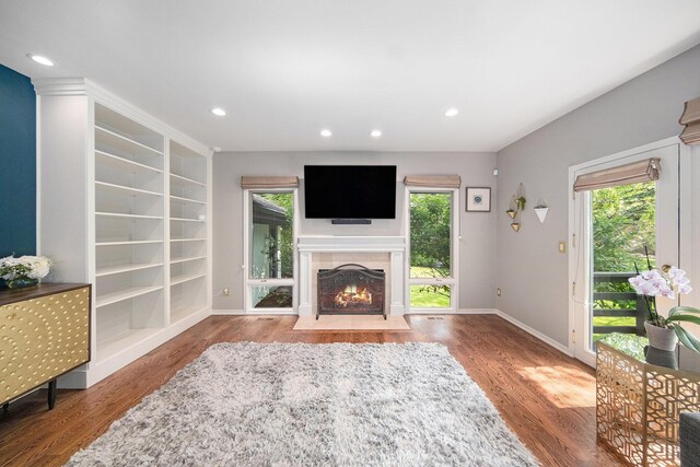 2002 Valleyview Dr, Ann Arbor, MI 48105 - unfurnished living room featuring healthy amount of natural light, wood finished floors, a fireplace with flush hearth, and recessed lighting
