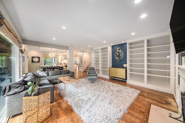 2002 Valleyview Dr, Ann Arbor, MI 48105 - living room featuring wood finished floors, recessed lighting, built in features, and stairway
