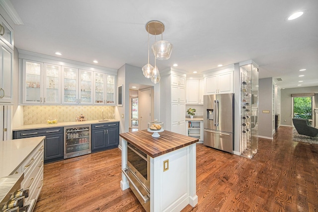 2002 Valleyview Dr, Ann Arbor, MI 48105 - kitchen featuring stainless steel fridge with ice dispenser, wine cooler, wooden counters, white cabinetry, and a sink