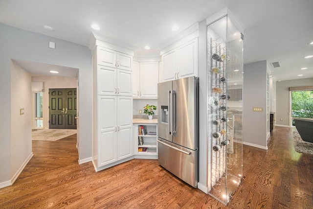 2002 Valleyview Dr, Ann Arbor, MI 48105 - kitchen with stainless steel fridge, wood finished floors, white cabinetry, baseboards, and recessed lighting