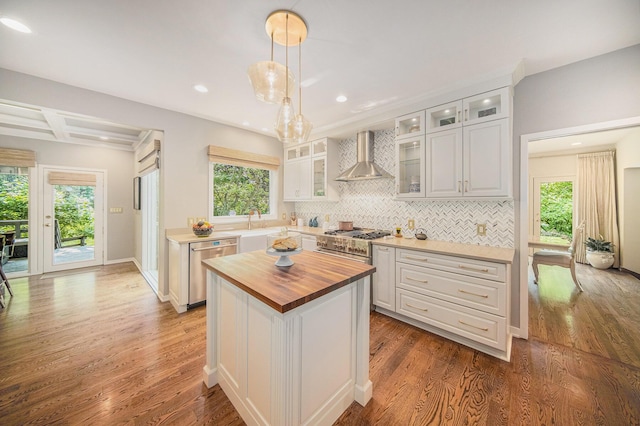 2002 Valleyview Dr, Ann Arbor, MI 48105 - kitchen with wood counters, wall chimney exhaust hood, appliances with stainless steel finishes, wood finished floors, and decorative backsplash