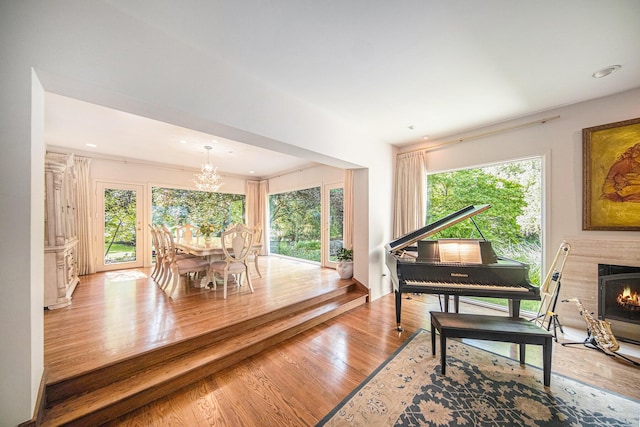2002 Valleyview Dr, Ann Arbor, MI 48105 - living room with a chandelier, wood finished floors, a fireplace, and recessed lighting