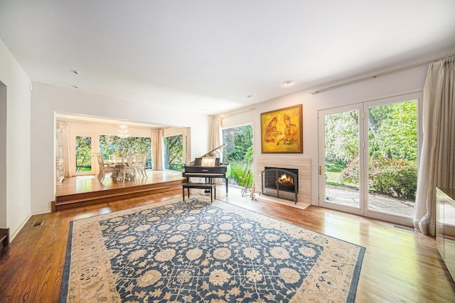 2002 Valleyview Dr, Ann Arbor, MI 48105 - living area featuring wood finished floors, a fireplace with flush hearth, and a chandelier