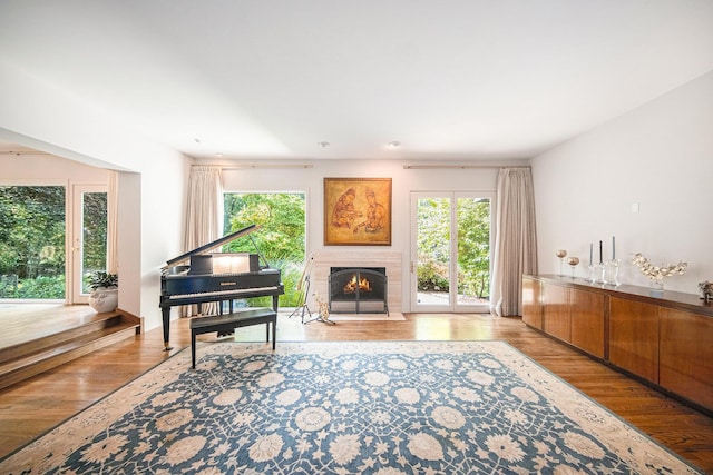 2002 Valleyview Dr, Ann Arbor, MI 48105 - living area with healthy amount of natural light, wood finished floors, and a warm lit fireplace