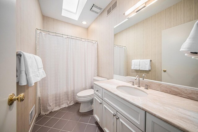 2002 Valleyview Dr, Ann Arbor, MI 48105 - full bathroom with tile patterned flooring, a skylight, vanity, and shower / tub combo with curtain
