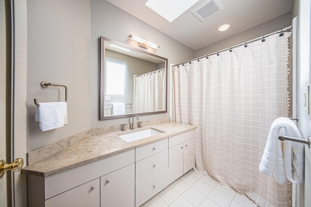2002 Valleyview Dr, Ann Arbor, MI 48105 - full bath featuring vanity, tile patterned floors, and a skylight