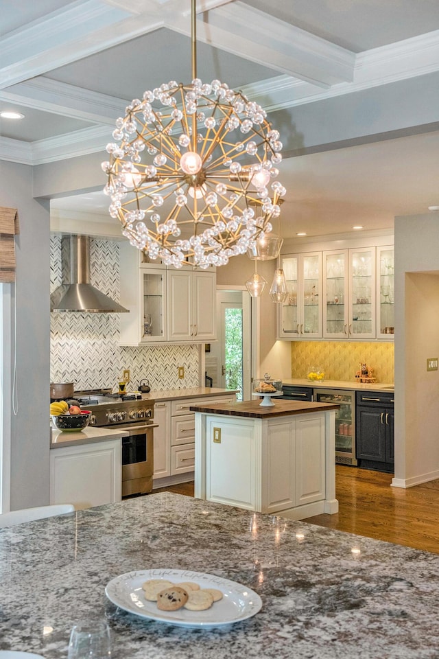 2002 Valleyview Dr, Ann Arbor, MI 48105 - kitchen featuring wall chimney range hood, high end range, wine cooler, decorative backsplash, and beam ceiling