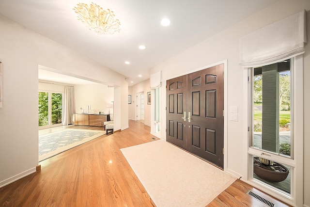 2002 Valleyview Dr, Ann Arbor, MI 48105 - foyer with plenty of natural light, wood finished floors, baseboards, recessed lighting, and vaulted ceiling