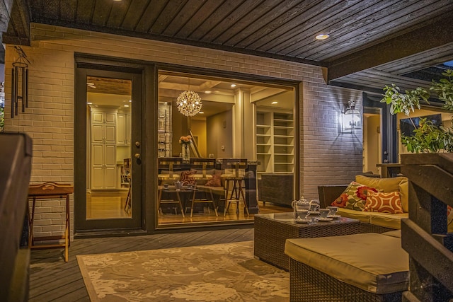 2002 Valleyview Dr, Ann Arbor, MI 48105 - wine area featuring hardwood / wood-style flooring, wood ceiling, brick wall, and a chandelier