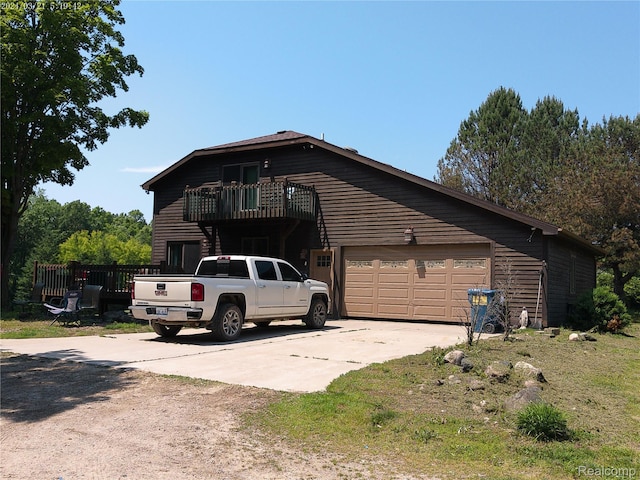 6140 Mcguire Rd, Fenton, MI 48430 - view of side of property with a balcony, driveway, and a garage