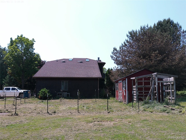 6140 Mcguire Rd, Fenton, MI 48430 - back of property with an outdoor structure and a chimney
