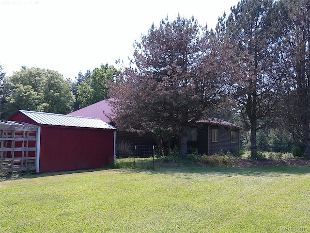 6140 Mcguire Rd, Fenton, MI 48430 - view of yard featuring an outbuilding, a garage, and a pole building
