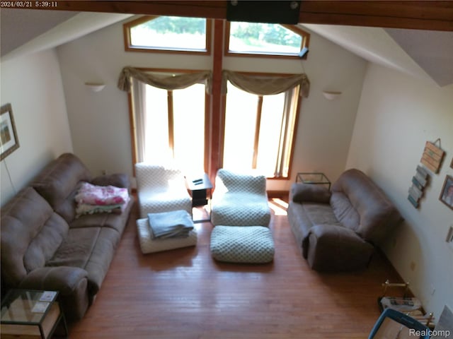 6140 Mcguire Rd, Fenton, MI 48430 - living room featuring healthy amount of natural light, vaulted ceiling, and wood finished floors
