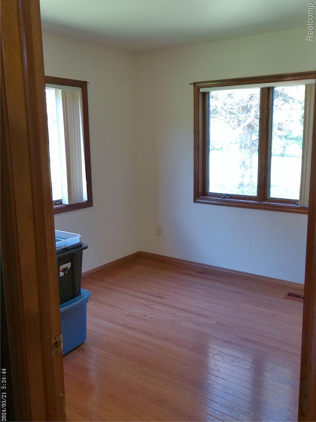 6140 Mcguire Rd, Fenton, MI 48430 - empty room with healthy amount of natural light and light wood finished floors