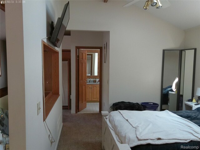 6140 Mcguire Rd, Fenton, MI 48430 - carpeted bedroom featuring vaulted ceiling and connected bathroom