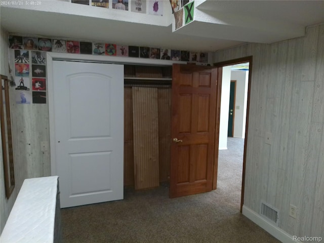 6140 Mcguire Rd, Fenton, MI 48430 - unfurnished bedroom featuring carpet floors, a closet, and wooden walls