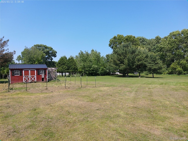 6140 Mcguire Rd, Fenton, MI 48430 - view of green lawn with a storage unit