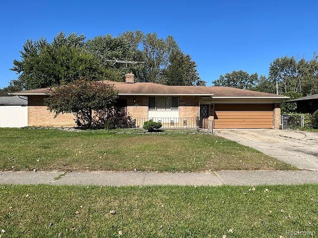 21451 N Nunneley Rd, Shelby Twp, MI 48036 - view of front of property with an attached garage, brick siding, a front yard, and driveway