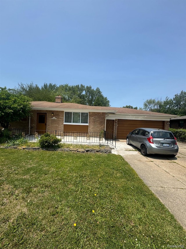 21451 N Nunneley Rd, Shelby Twp, MI 48036 - single story home with brick siding, driveway, a garage, a front lawn, and a chimney